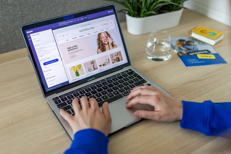 Person typing on a laptop in a home office