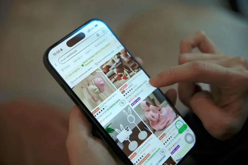 Smartphone with subscribe screen surrounded by dried flowers, digital creator setup