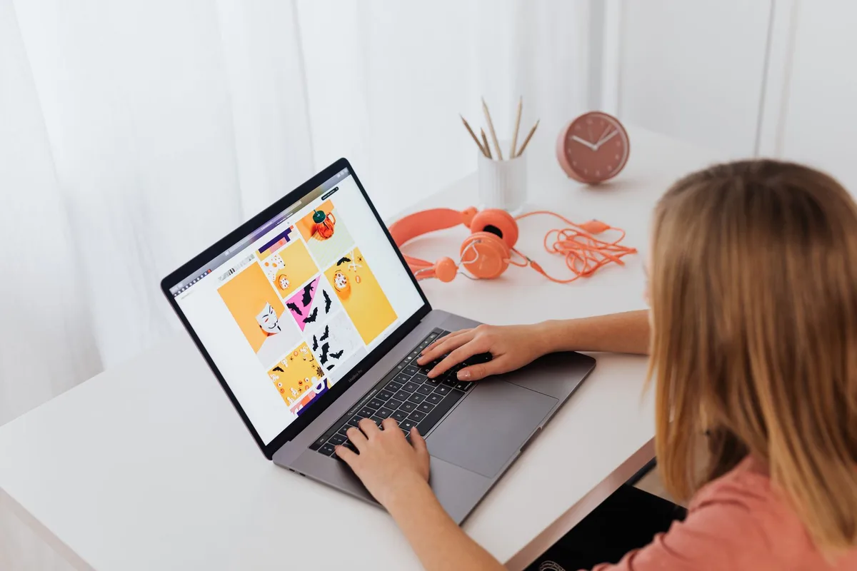 Creator working at a laptop in a clean home office setup