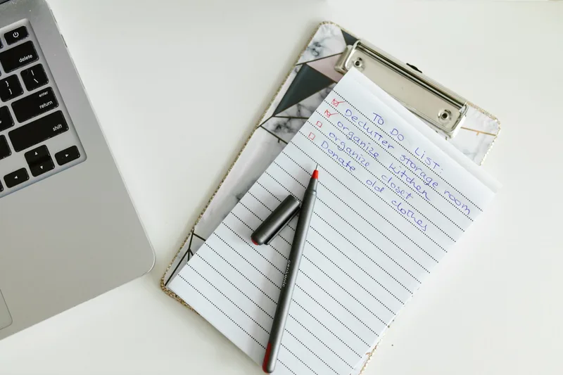 Checklist and planning notes on a desk, showing the preparation process for a digital product launch