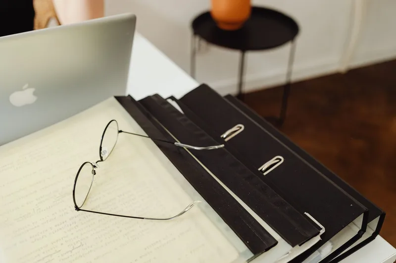MacBook Pro on a minimalist workspace desk for digital product creation and file organization