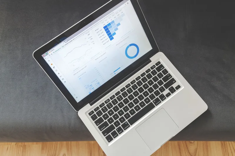 Person browsing digital product listings on a laptop to research competitor pricing on Etsy
