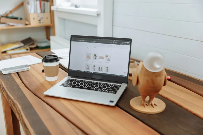Comparison of artwork selling platforms on a laptop screen