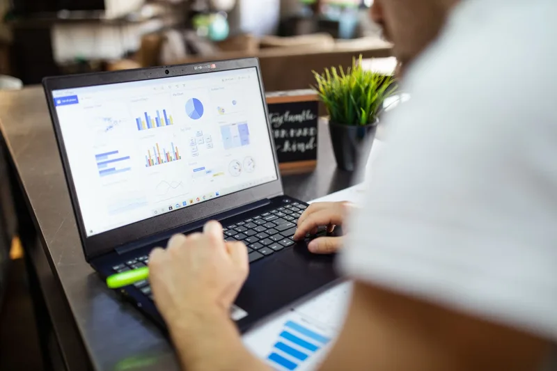 Laptop screen showing a digital art shop dashboard with pricing set for printable products and bundles