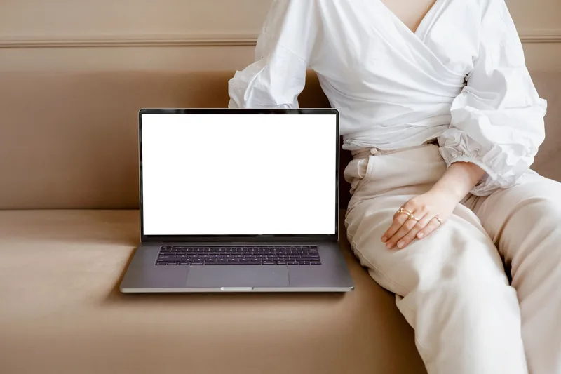 Creator reviewing Canva template analytics dashboard on laptop screen
